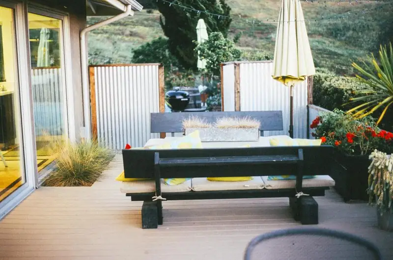 A modern deck with outdoor seating and planters
